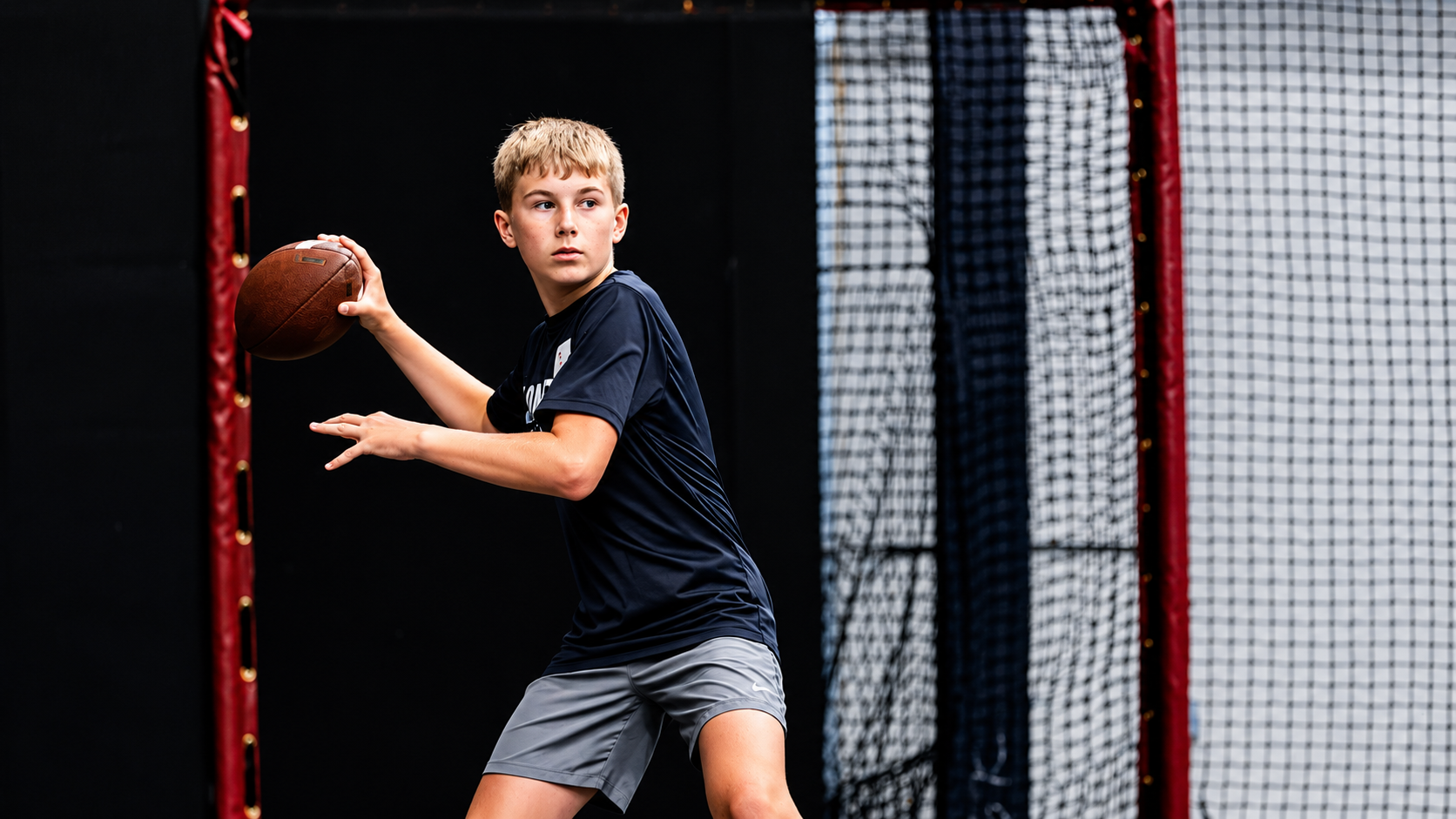 Football player handling the ball during training.