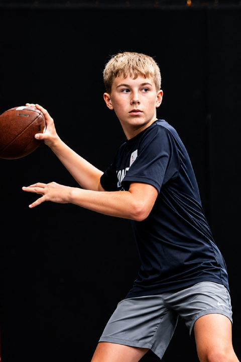 Football player handling the ball during training.