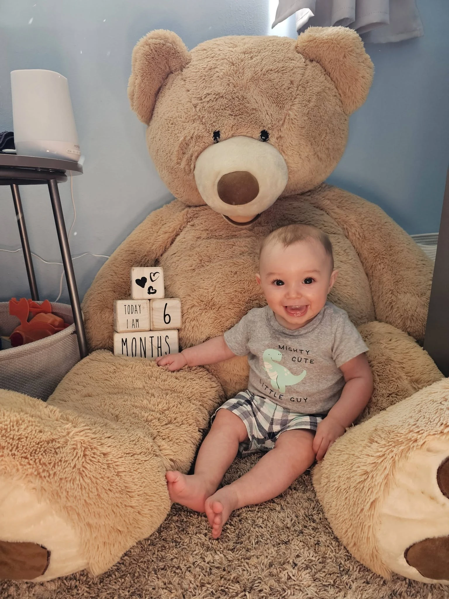 Landon Morawski at six months old, sitting with a large teddy bear