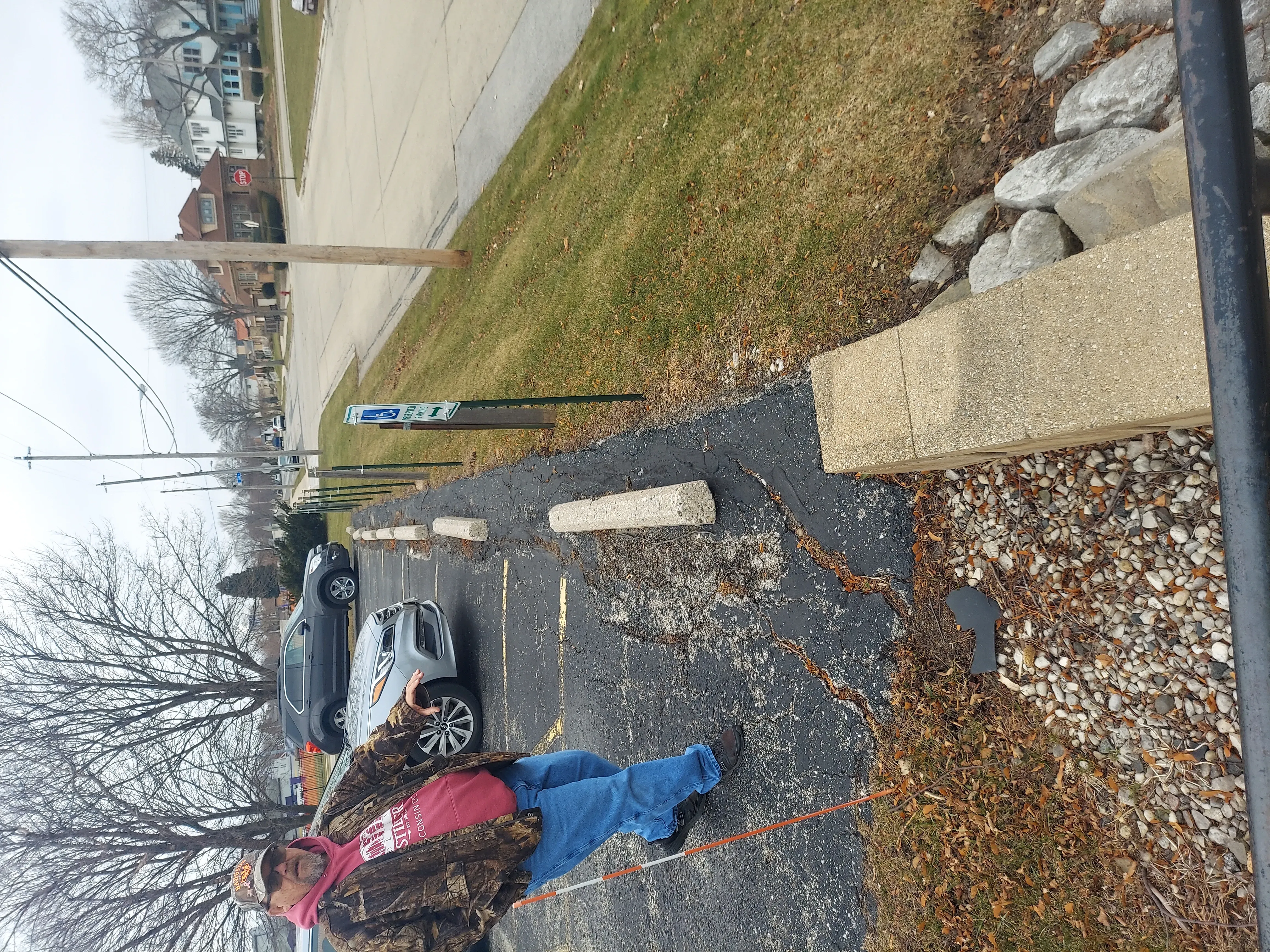Purpose Contracting Asphalt estimator measuring a parking lot during a site evaluation