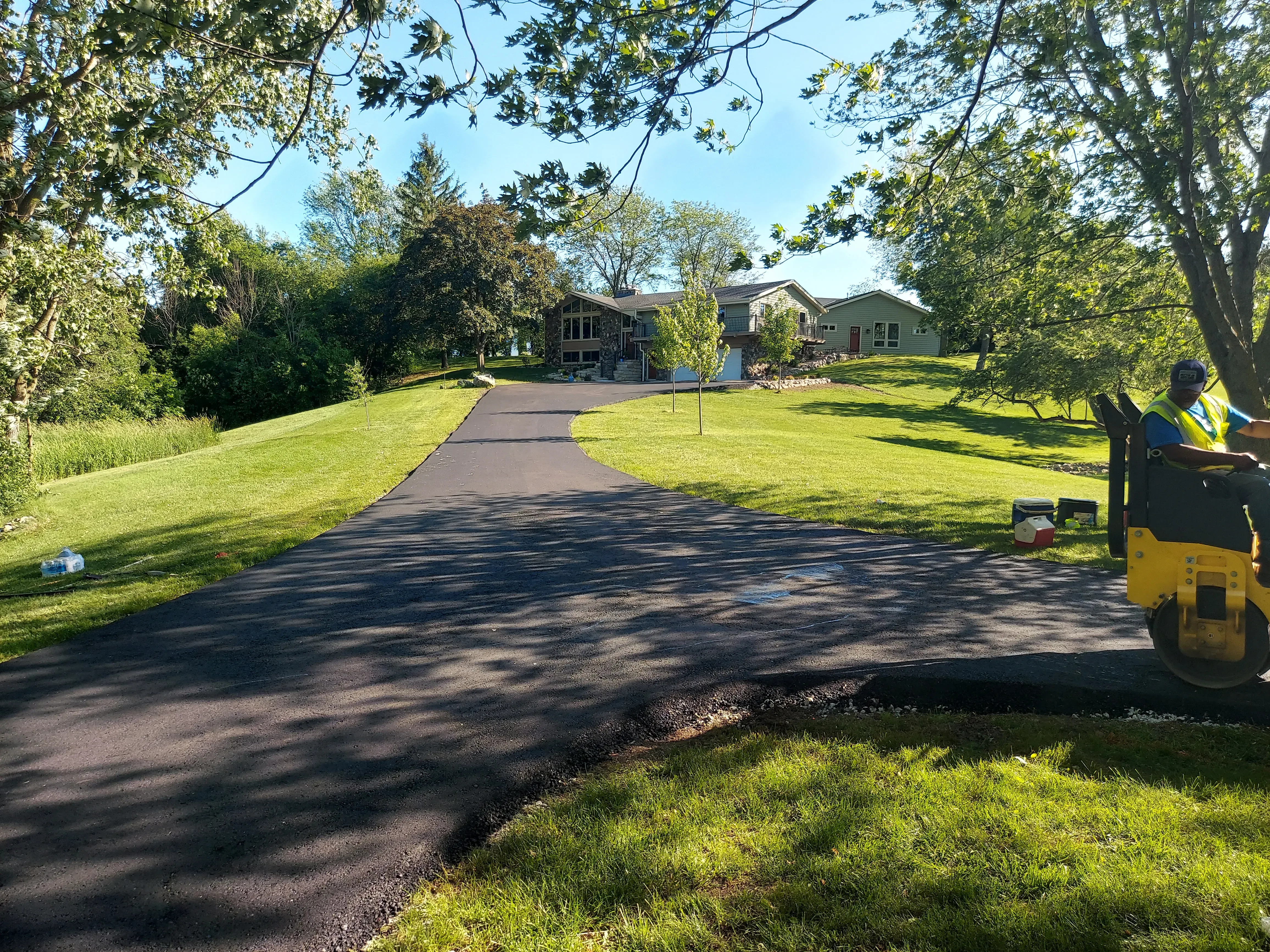 Roller compacting freshly laid asphalt