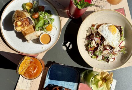 A table of colorful dishes and drinks at Mayan Cafe in Louisville
