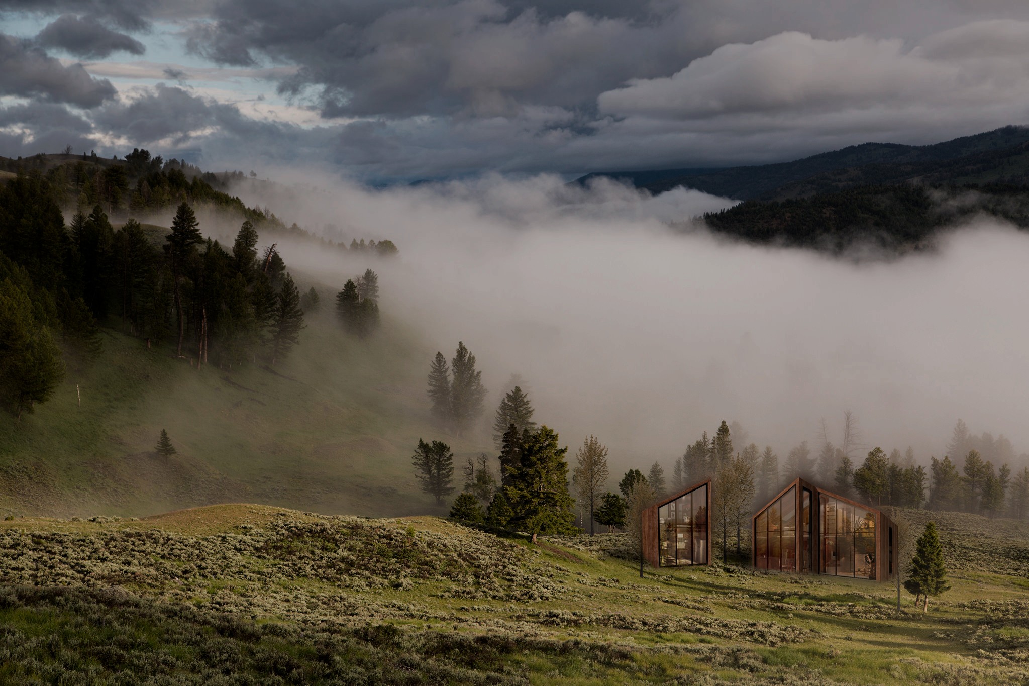 Two Tiny House WM volumes glowing at dusk in a fog-filled mountain valley