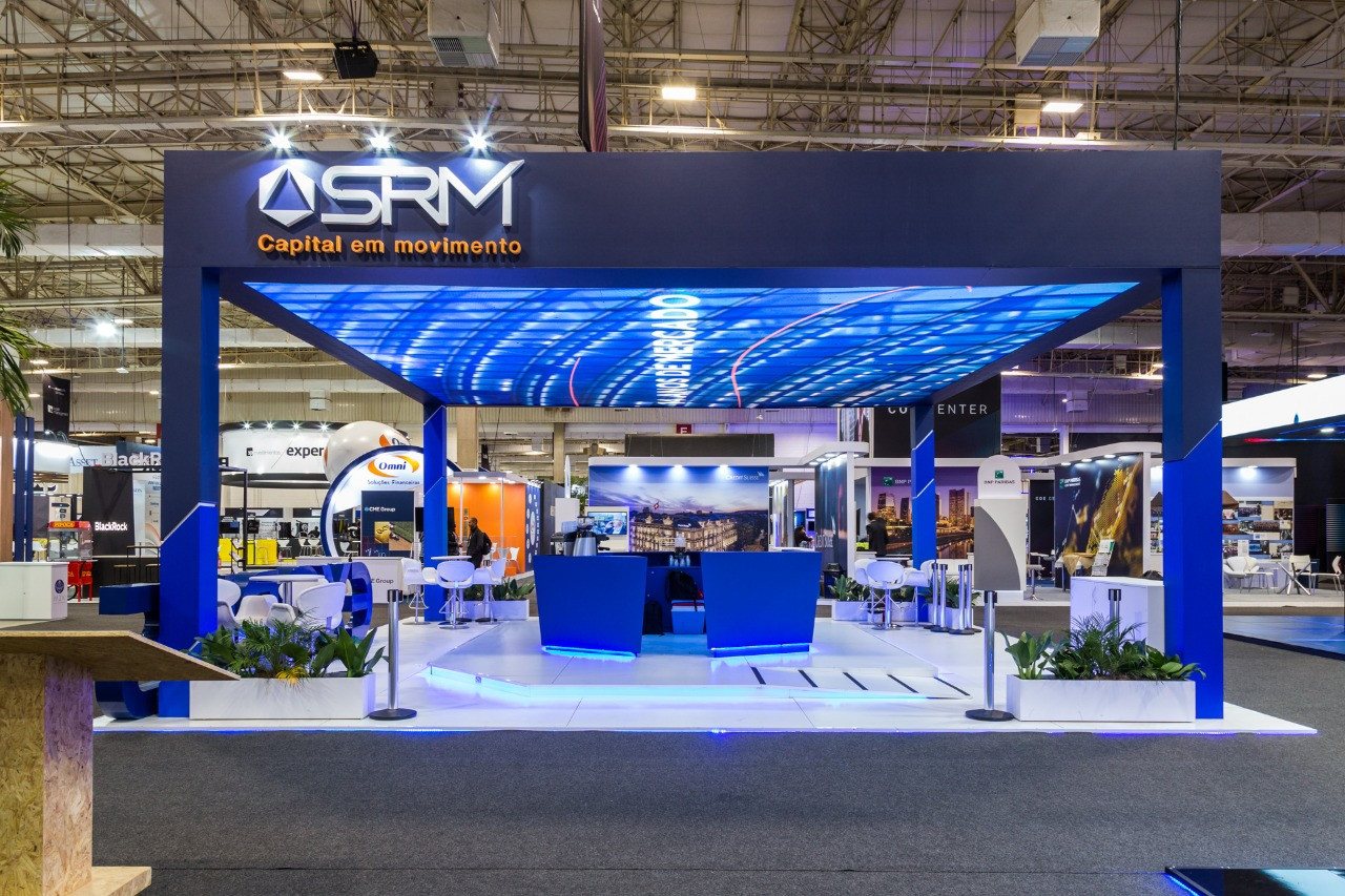 SRM · 2019 · Expert 2019 (XP) — An exhibition stand under a blue wave-form ceiling.