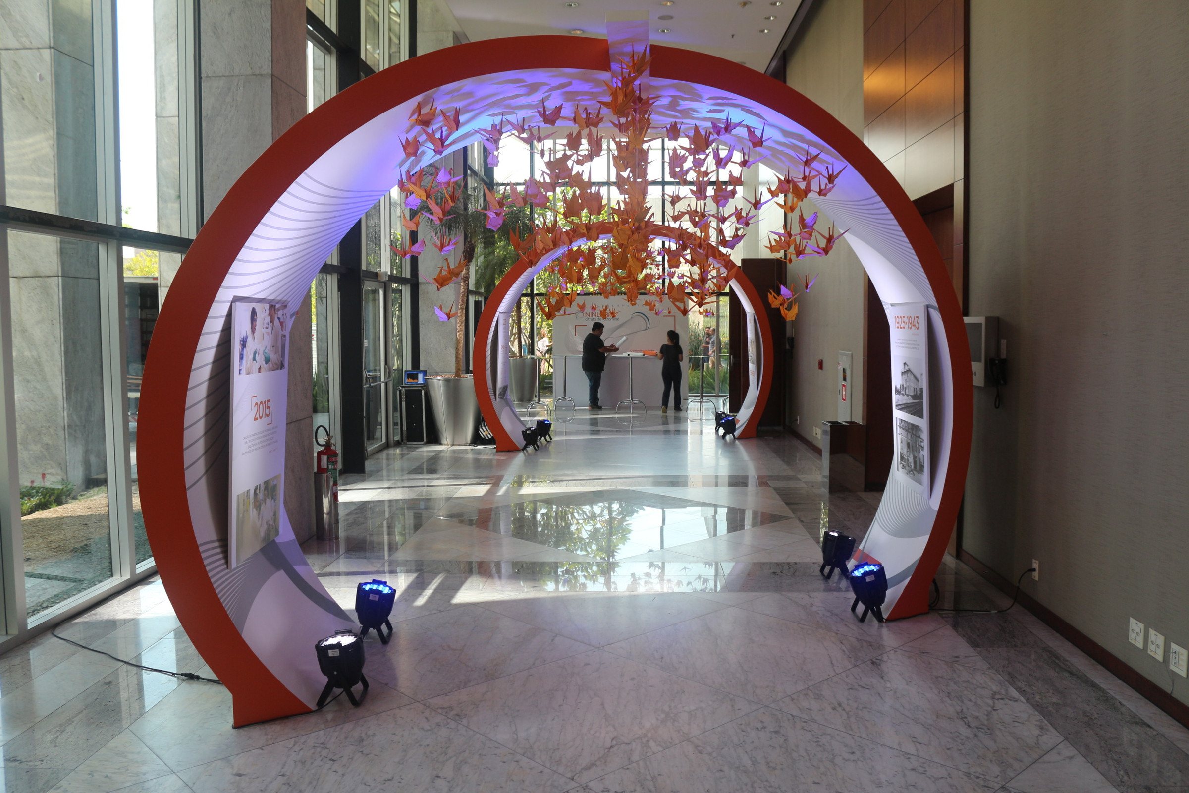 Takeda · 2018 — Reception: a circular red portal cut through the corridor, reflected in the polished floor.