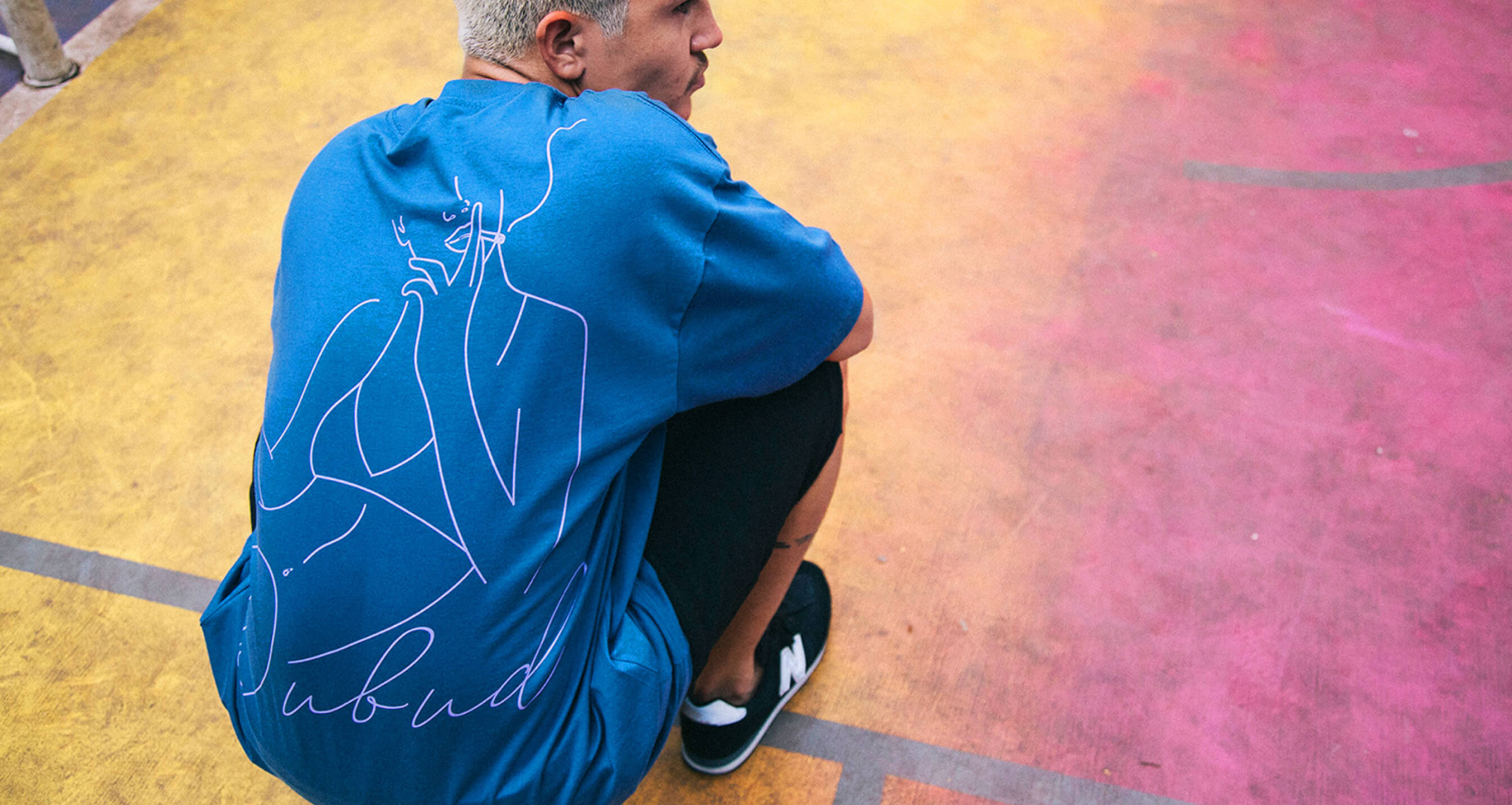 Dubud — line illustration printed on the back of a blue tee
