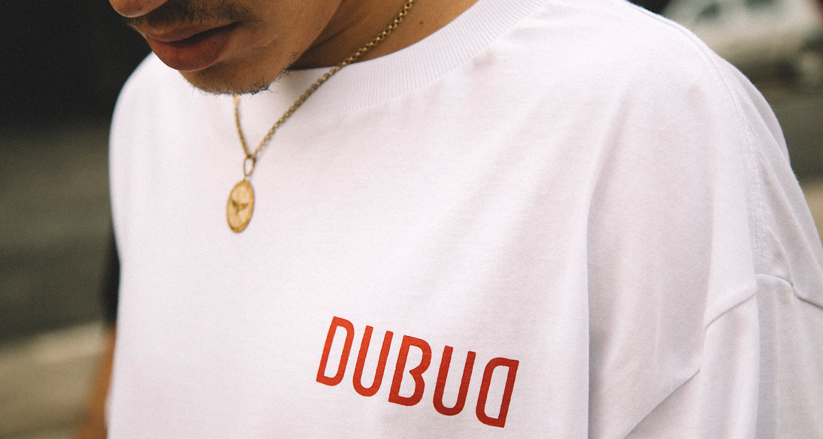 Dubud — red wordmark on a white tee