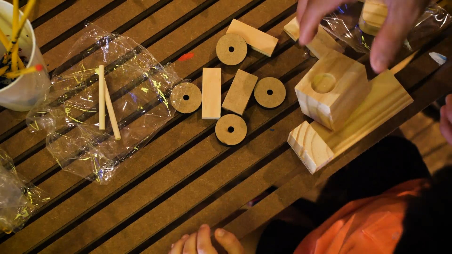 Wooden toy parts laid out on the bench