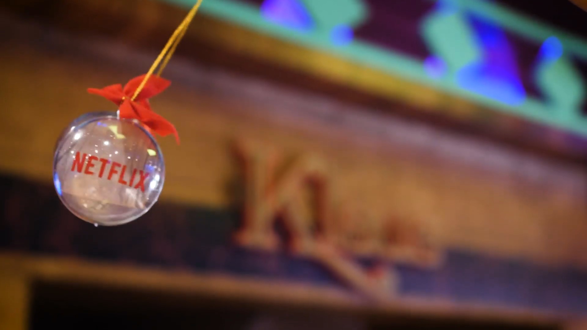 Netflix ornaments hanging in front of the Klaus sign