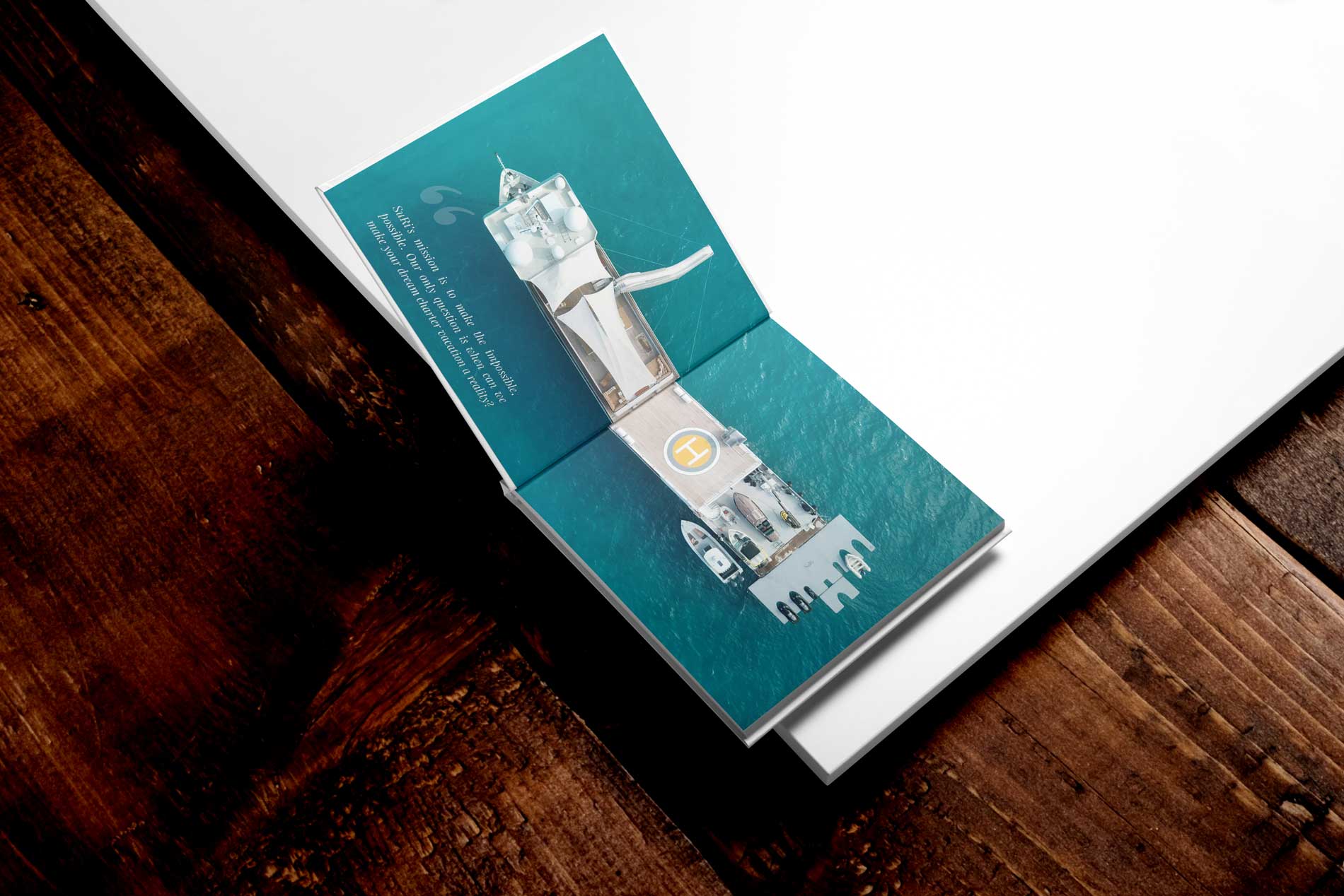 Open SuRi charter brochure with an overhead yacht photograph across the spread