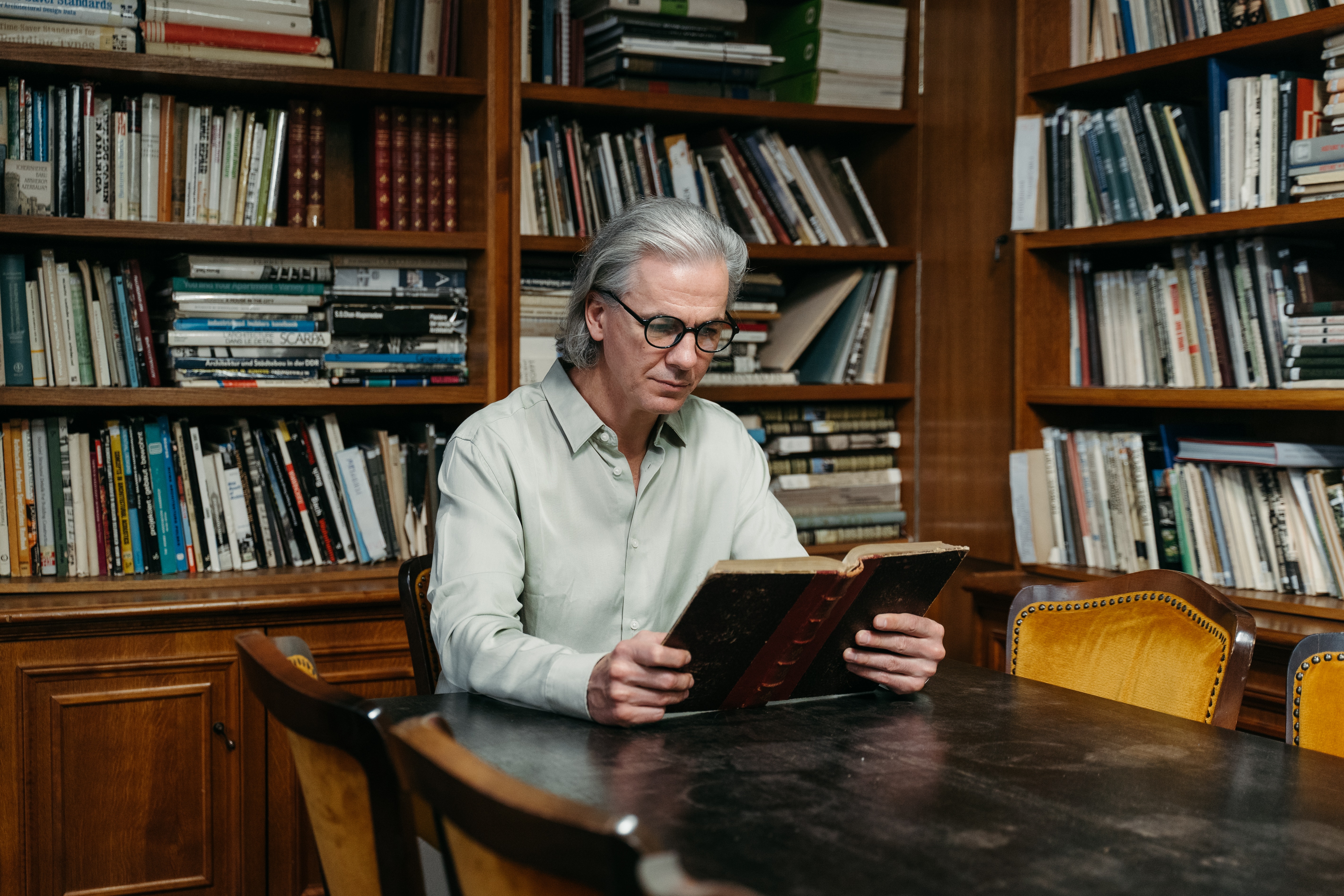 Man sitting in library stock image