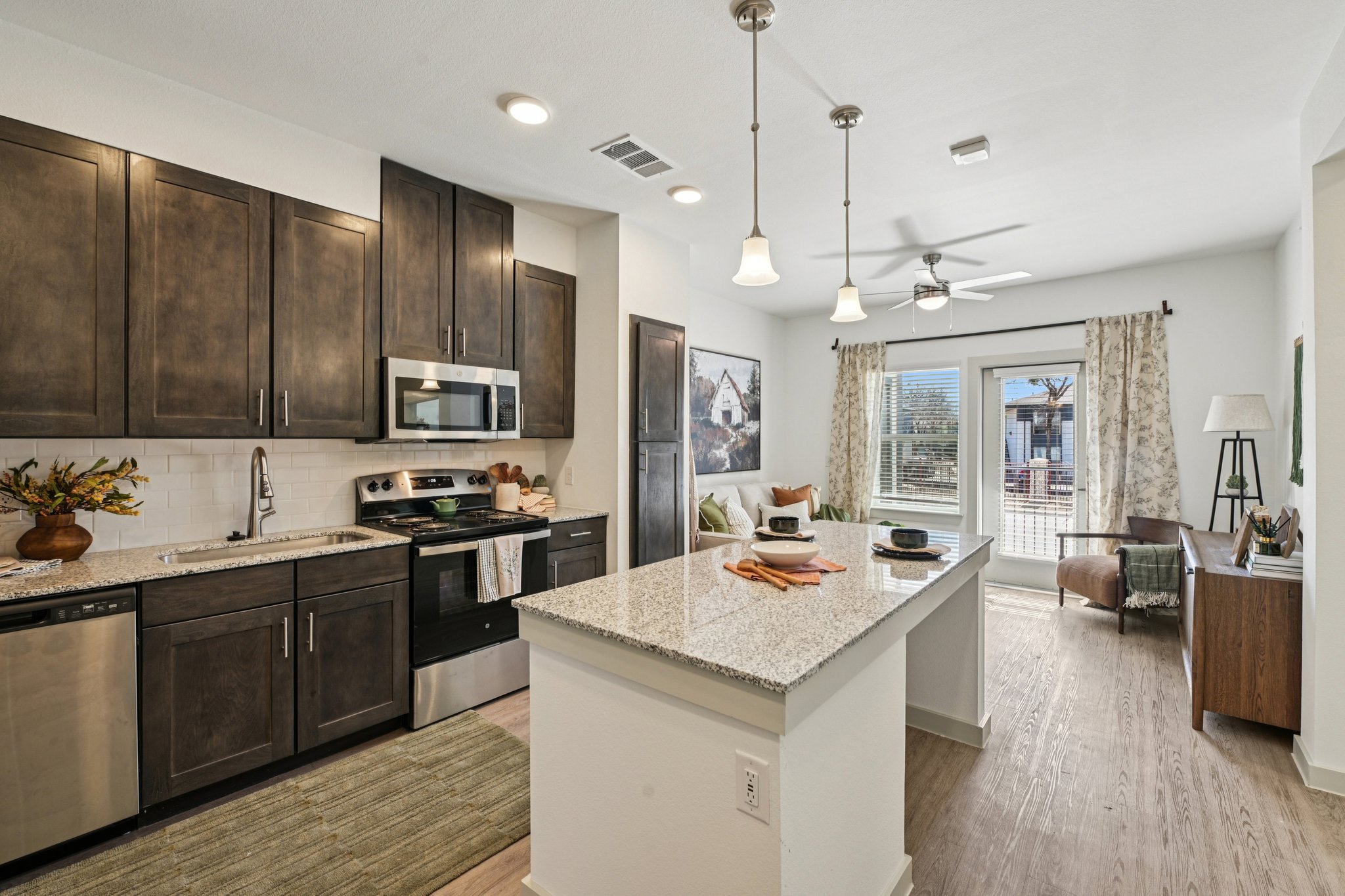 Kitchen with island, dark cabinets, and stainless steel appliances