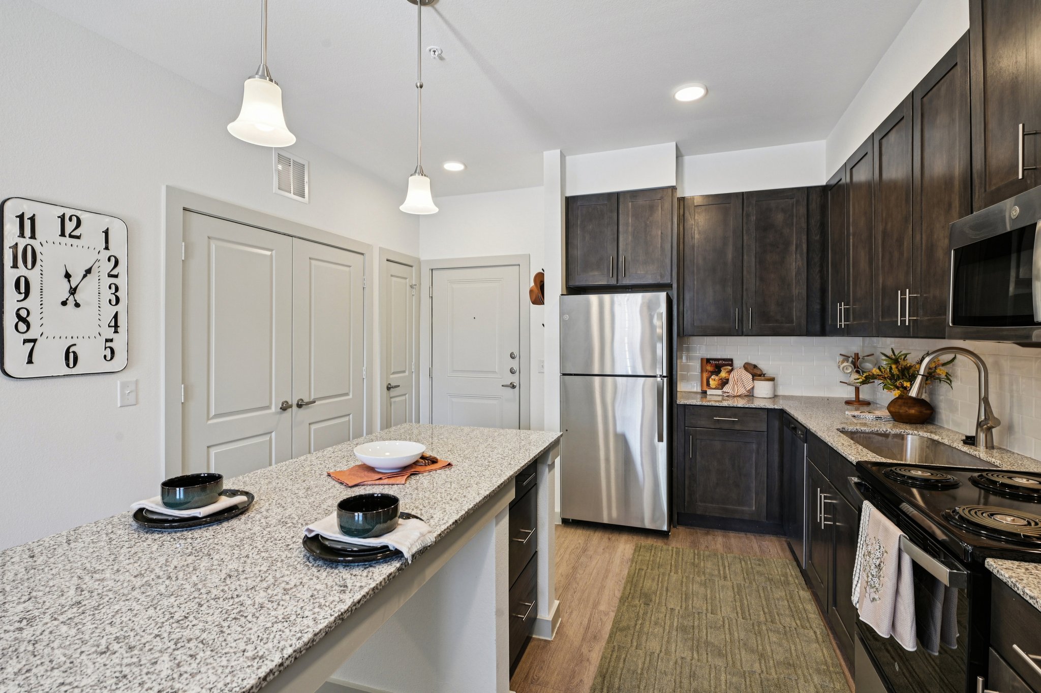 Kitchen with dark cabinets and stainless steel appliances