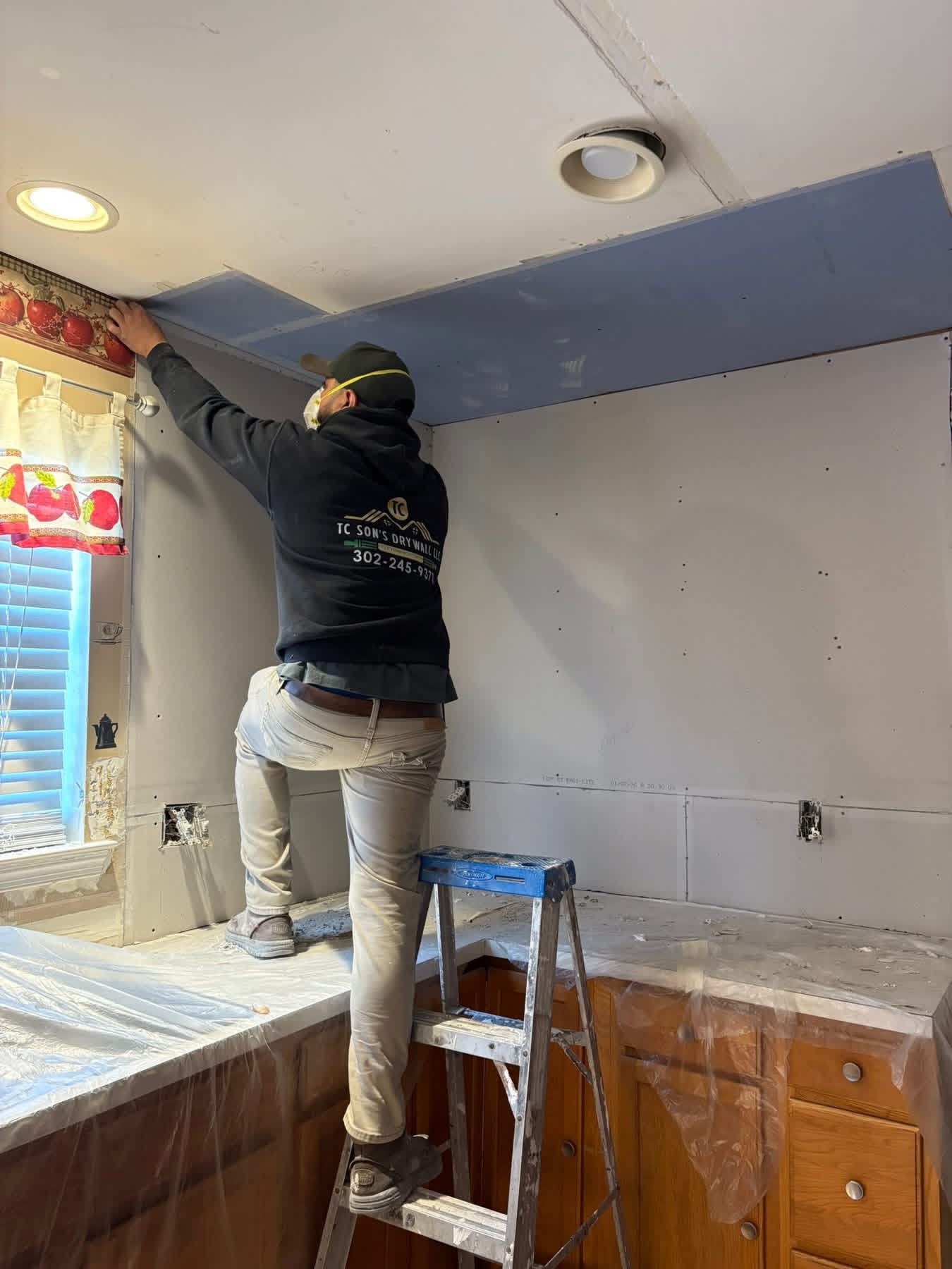 Tito finishing a drywall seam on a job site