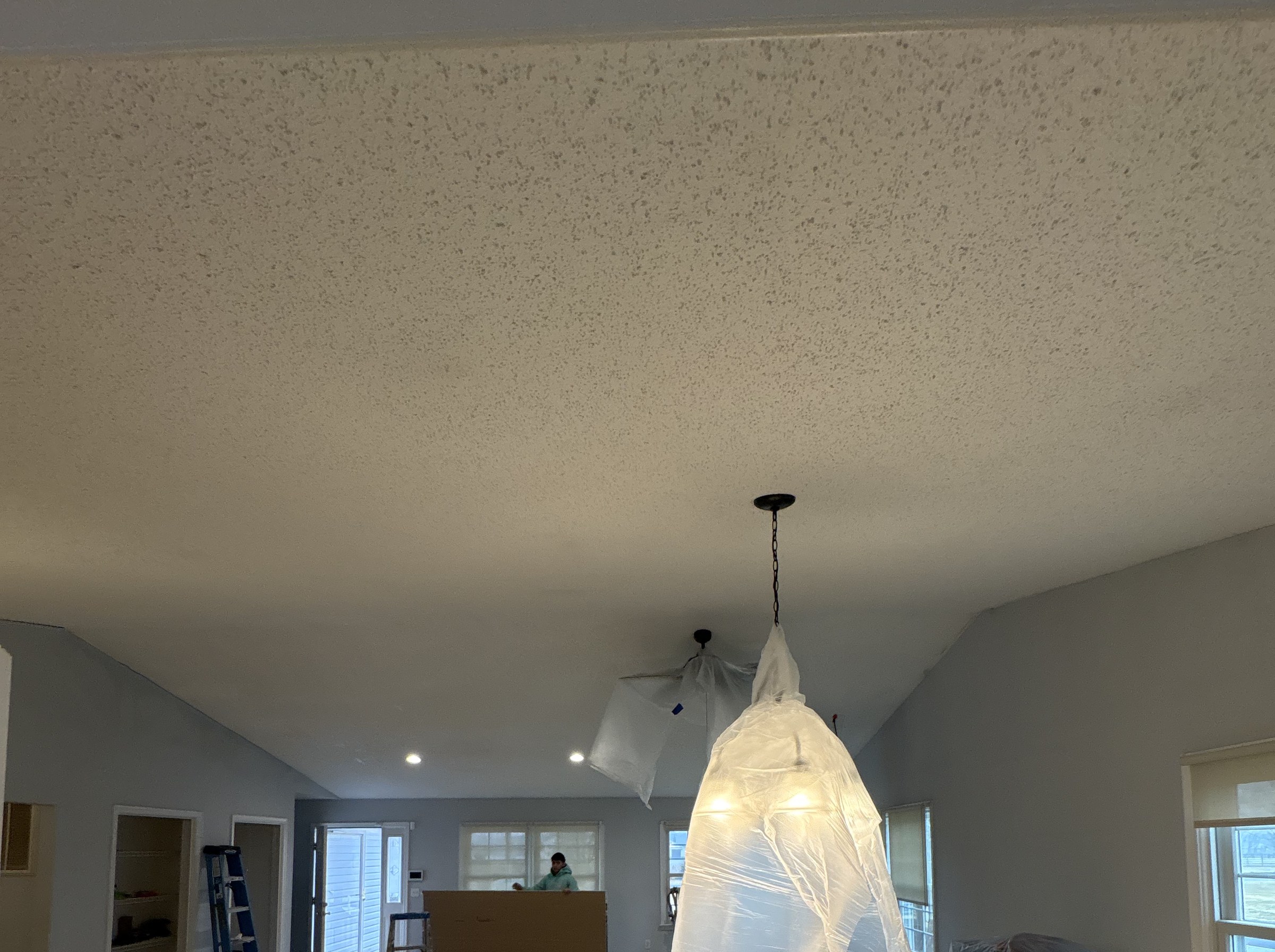 Popcorn ceiling removal from an open lving area