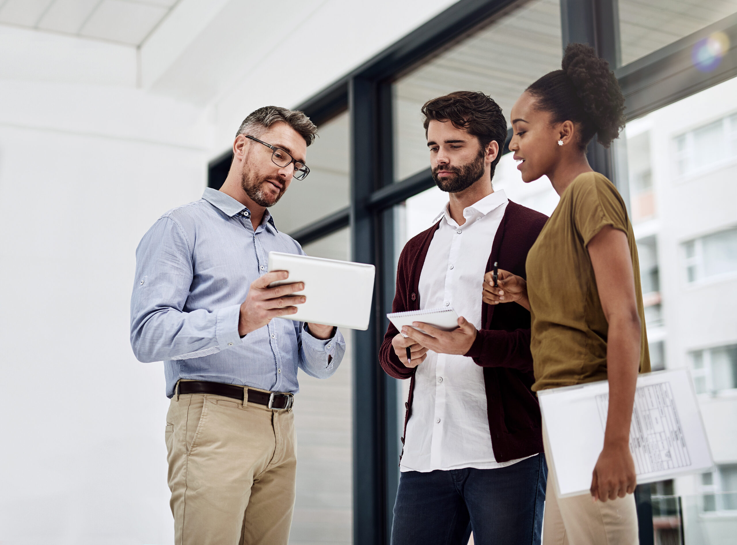 An engineer walking a client's IT team through a plan on a tablet