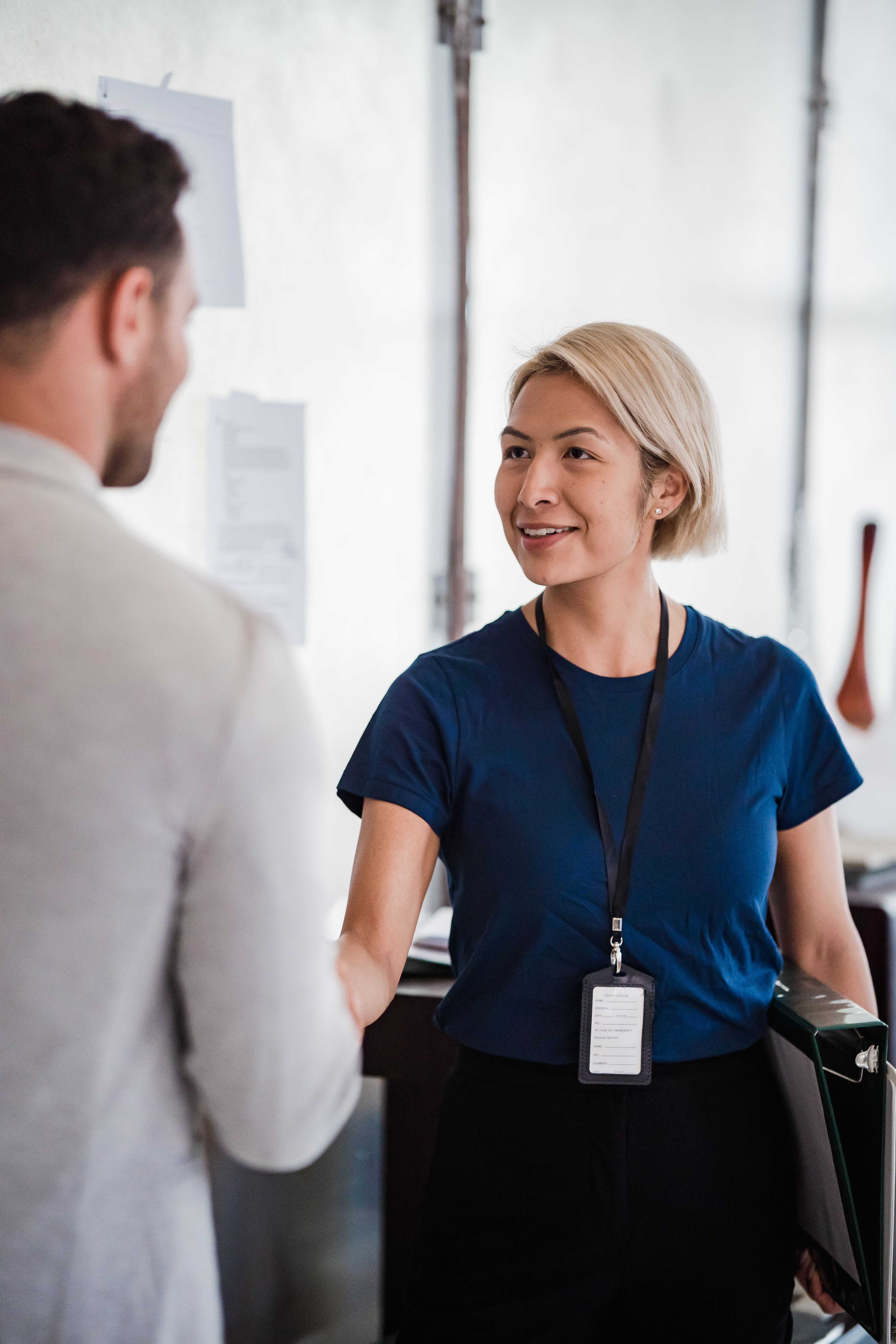 Woman speaking with a colleague at a networking event.