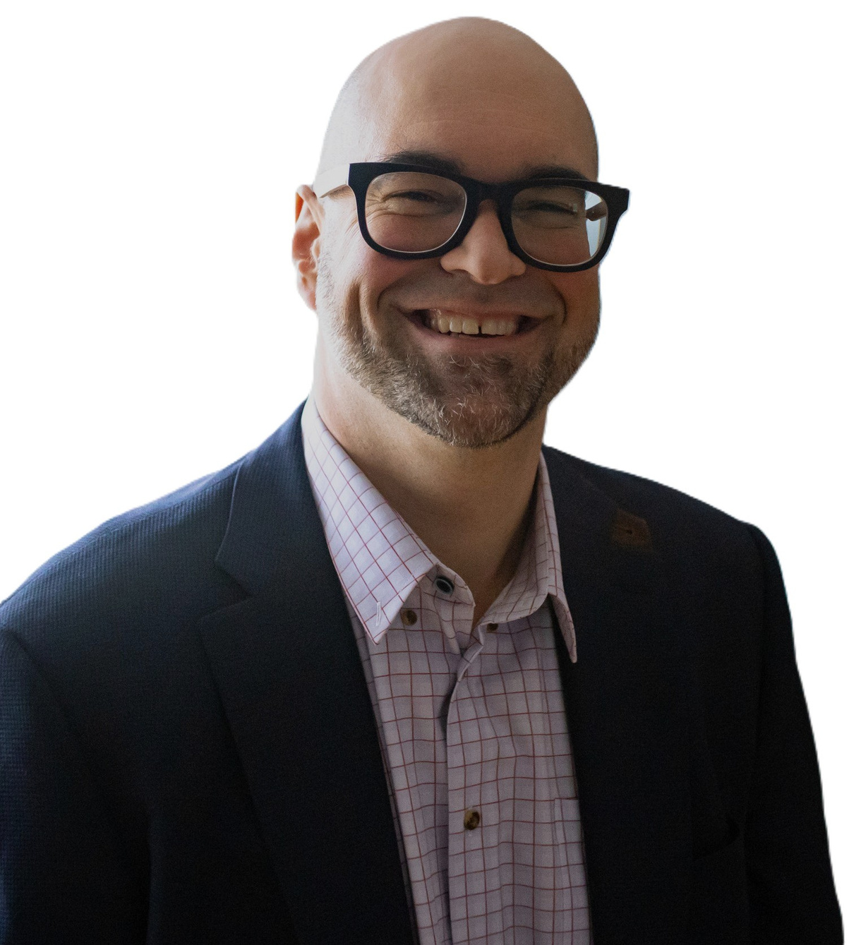 Smiling bald man wearing black glasses, checked shirt, and dark blazer on white background.