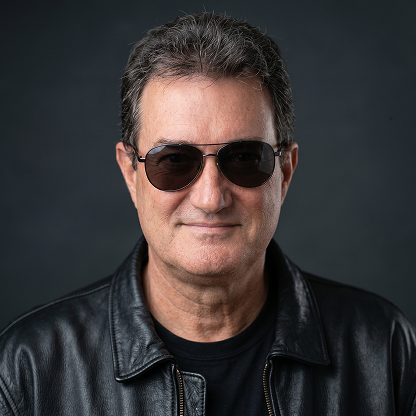 Middle-aged man wearing sunglasses and a black leather jacket against a dark background.