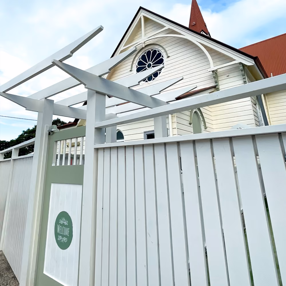 The cottage's white timber verandah railing and pergola.