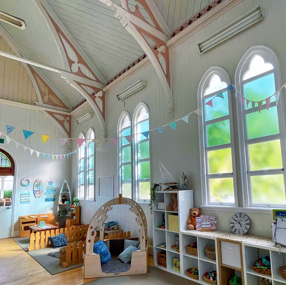 The cottage's heritage hall with arched windows, high timber ceilings and pastel bunting.