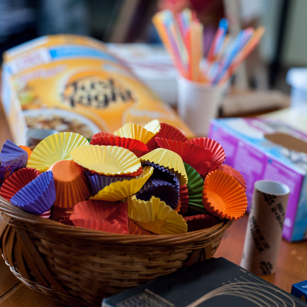 A colourful spill of paper cupcake cases set out for a craft activity.