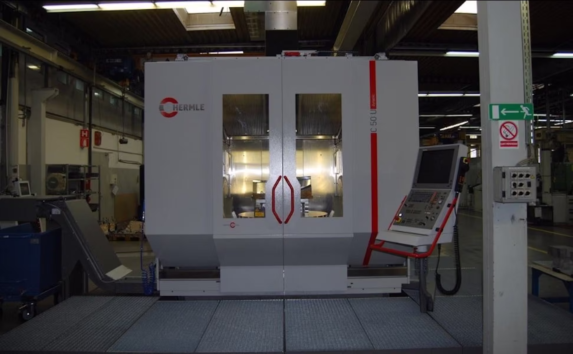 Hermle C50 five-axis machining centre, a white enclosed machine with red trim and a swing-arm control panel, on the shop floor.