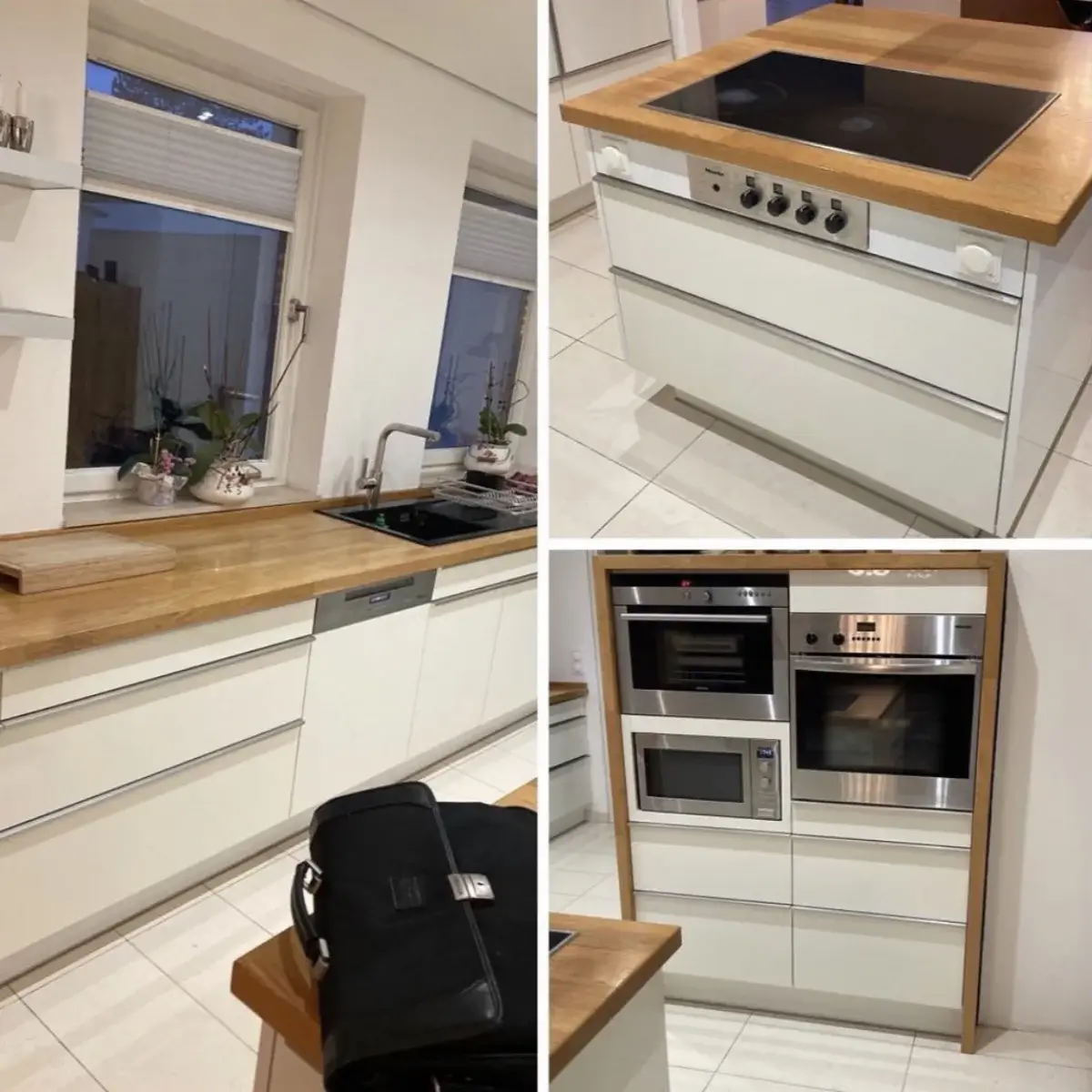 Moderne weiße Küche mit Holzarbeitsplatten, Kochfeld, Backofen, Mikrowelle und Spüle unter zwei Fenstern.