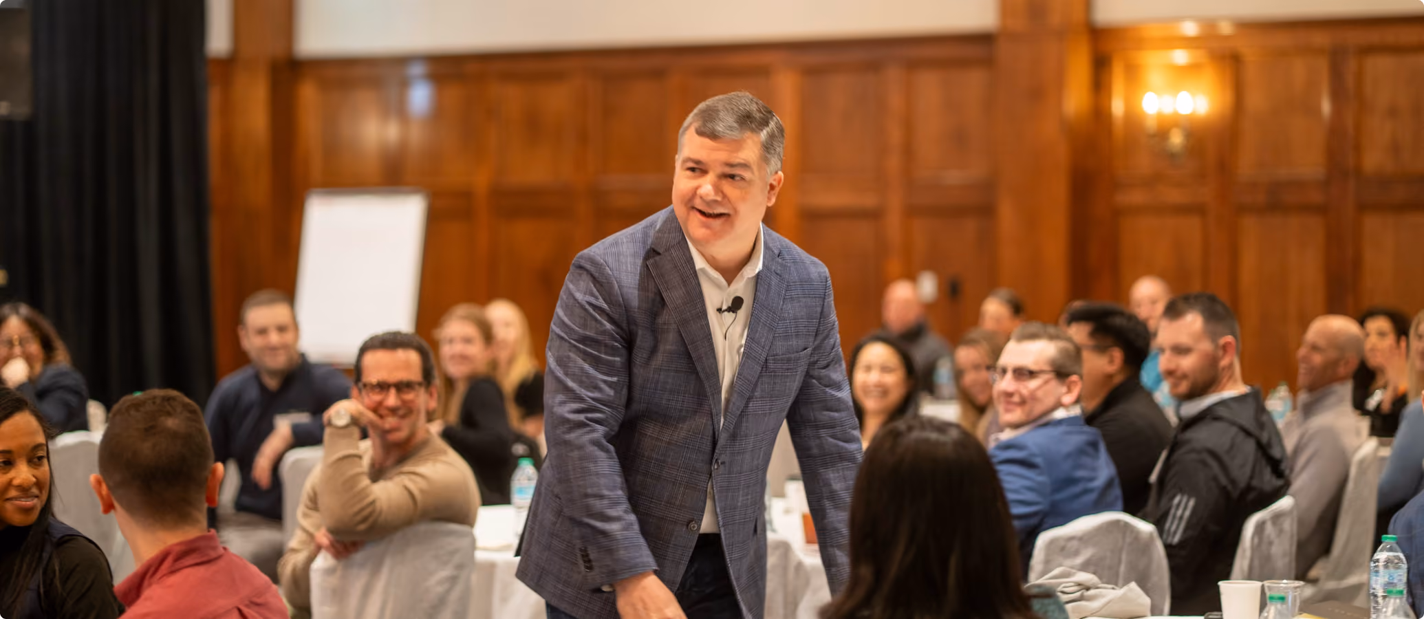 Robert "Cujo" Teschner, VMax Group founder, laughing with a room of leaders during a teamwork training session