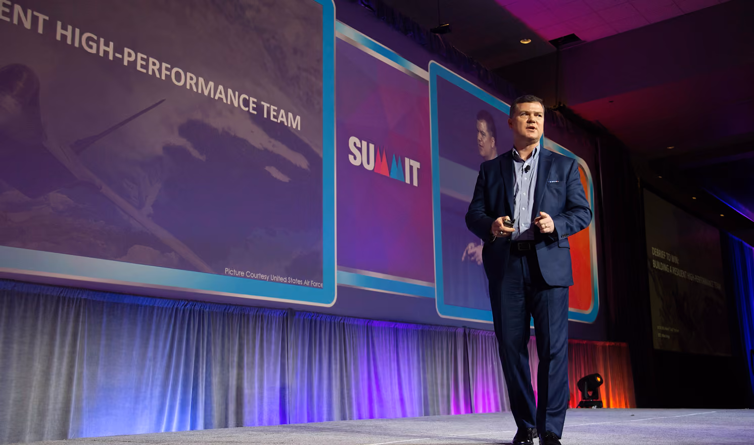 Robert "Cujo" Teschner delivering a leadership keynote on team accountability from a conference stage