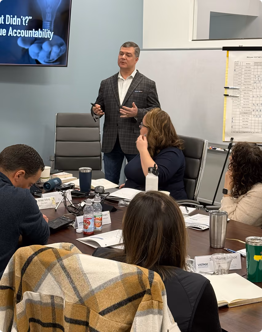 Robert "Cujo" Teschner teaching team accountability to a leadership team around a conference table