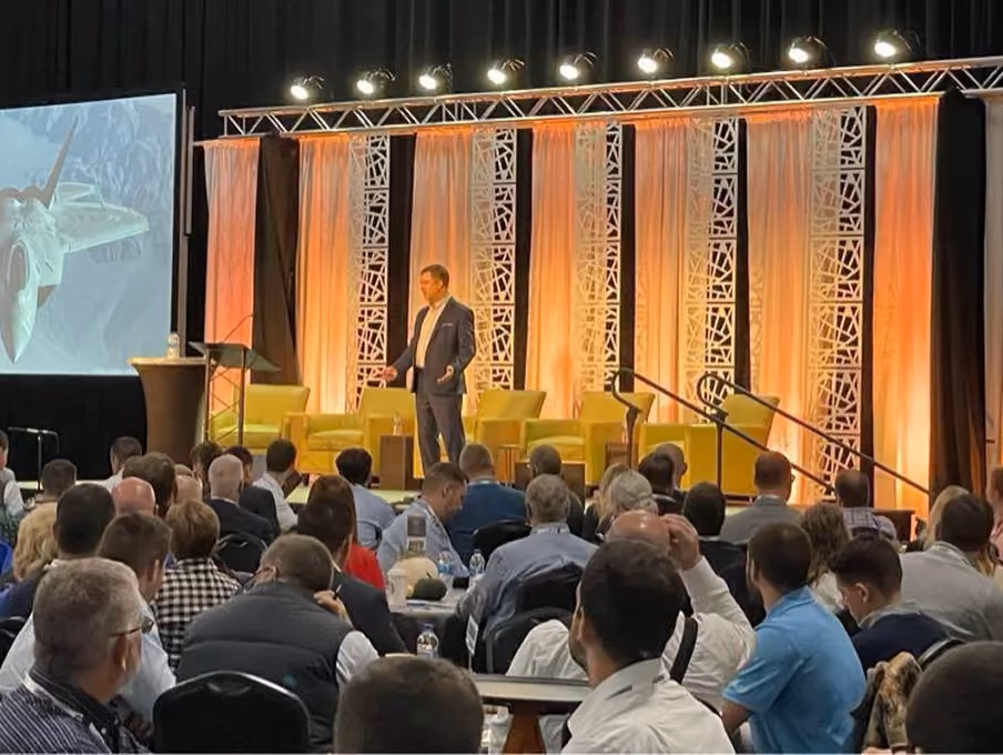 Robert "Cujo" Teschner delivering a VMax Group leadership keynote to a full conference hall