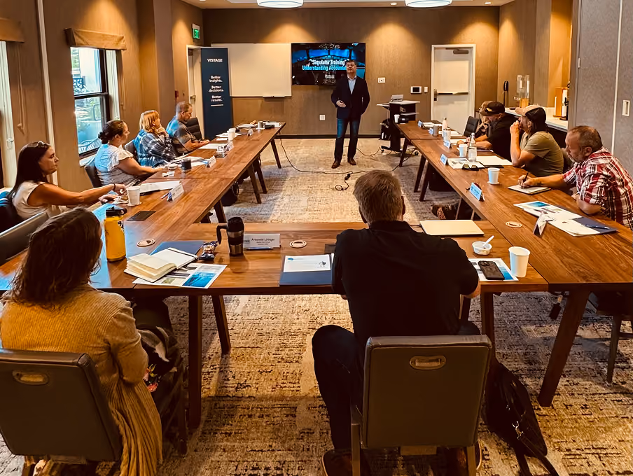 VMax Group leadership workshop in progress with a leadership team around a long boardroom table