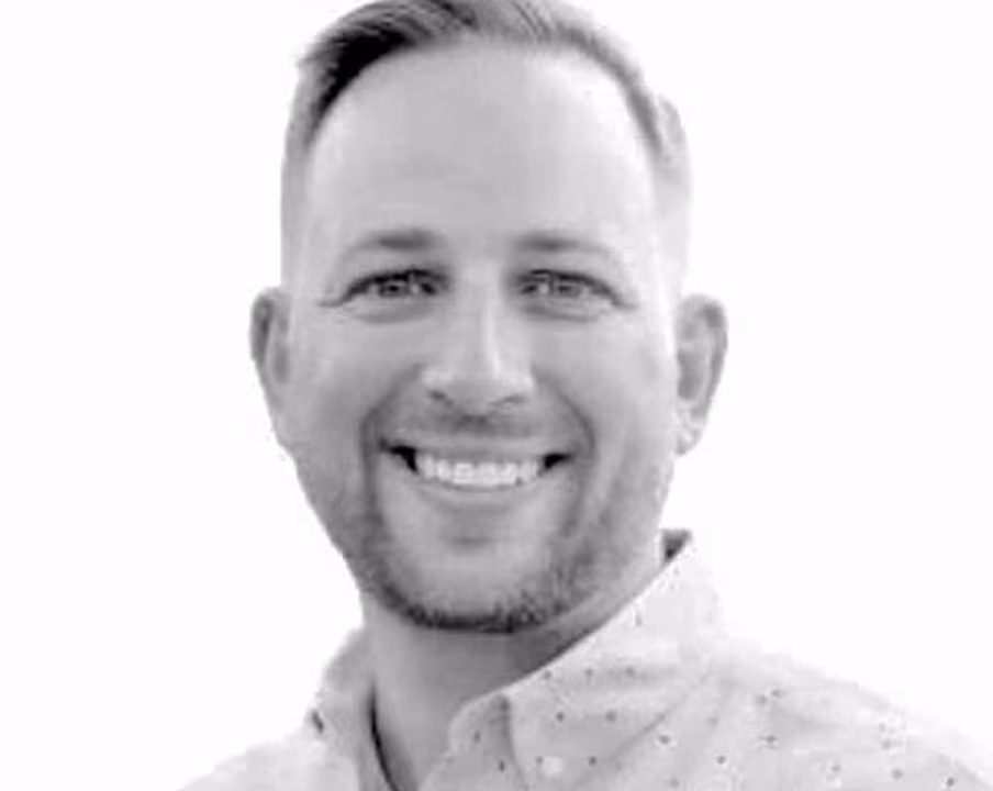 Black and white portrait of Luke "PSYCH" Layman, Chief Strategy Officer at VMax Group