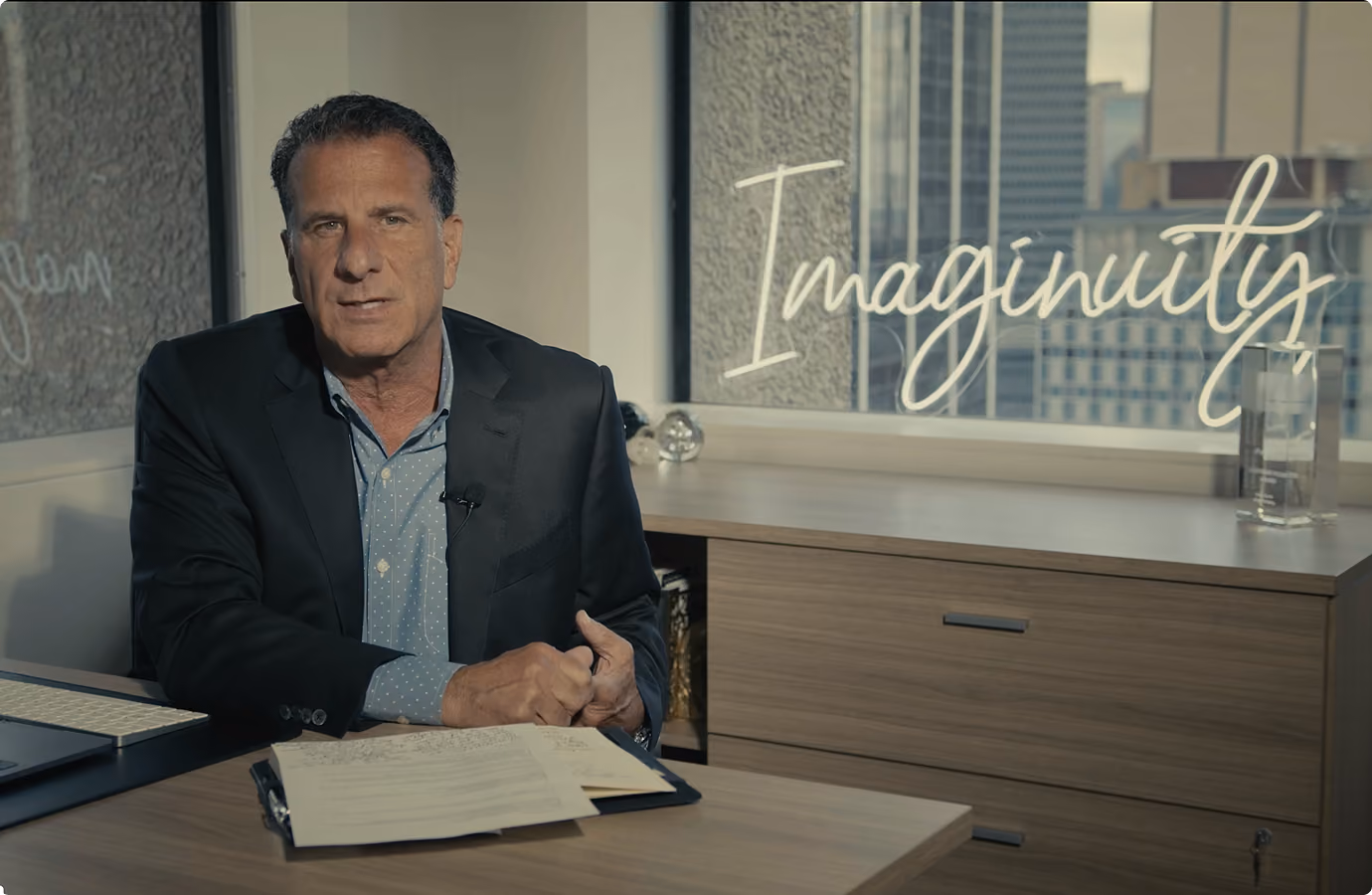Charlie Calise, CEO of Imaginuity, speaking on camera about VMax Group