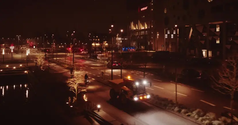 A dump truck driving down an urban road in Aalborg, Northern Denmark