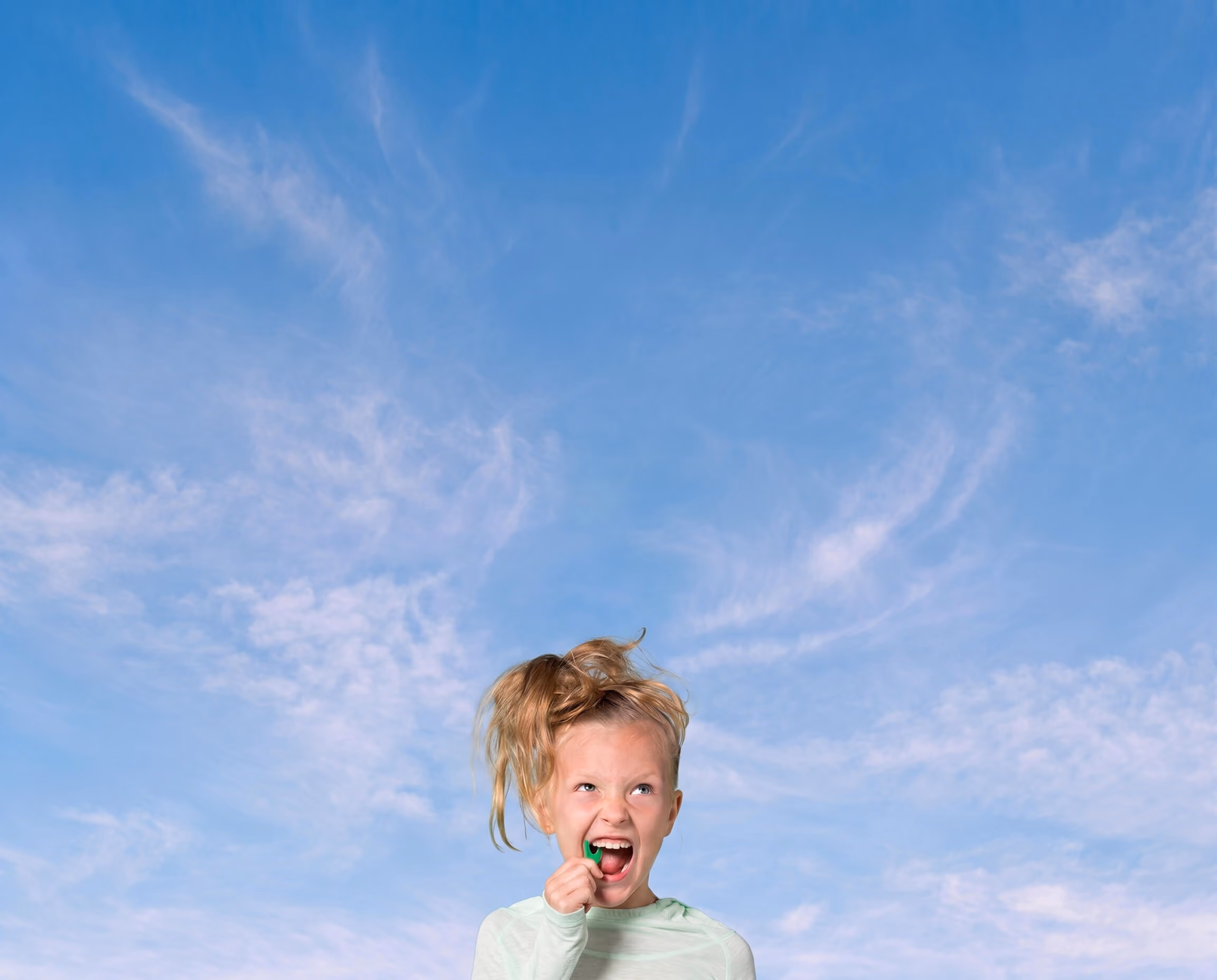 girl flossing her teeth