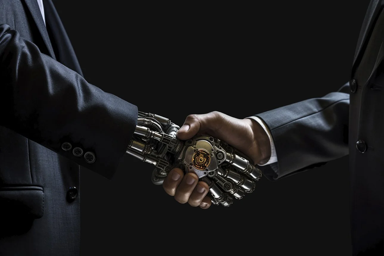 A robotic hand shaking hands with a businessman in a dark suit
