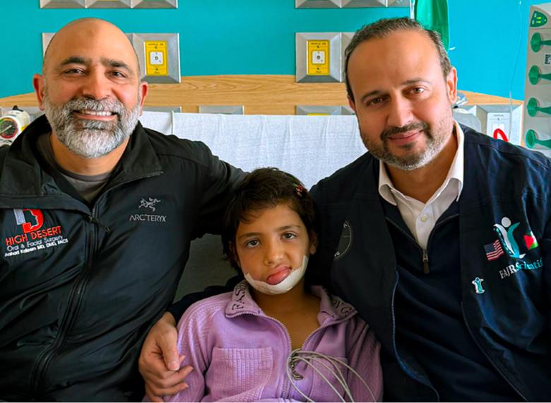 FAJR staff with a child in a classroom in Gaza.