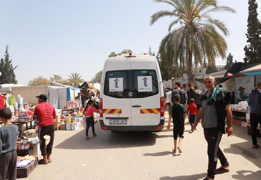A FAJR Scientific van amid a street market.