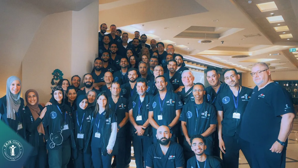 FAJR Global volunteer doctors, nurses and staff in navy scrubs gathered for a team photo