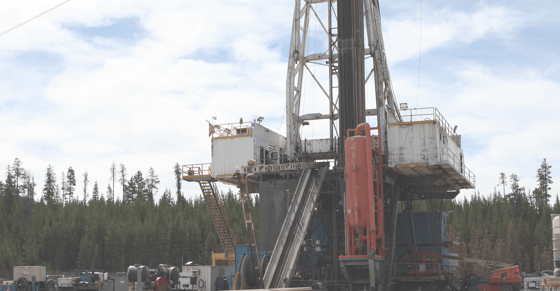 Geothermal drilling site with rig and equipment
