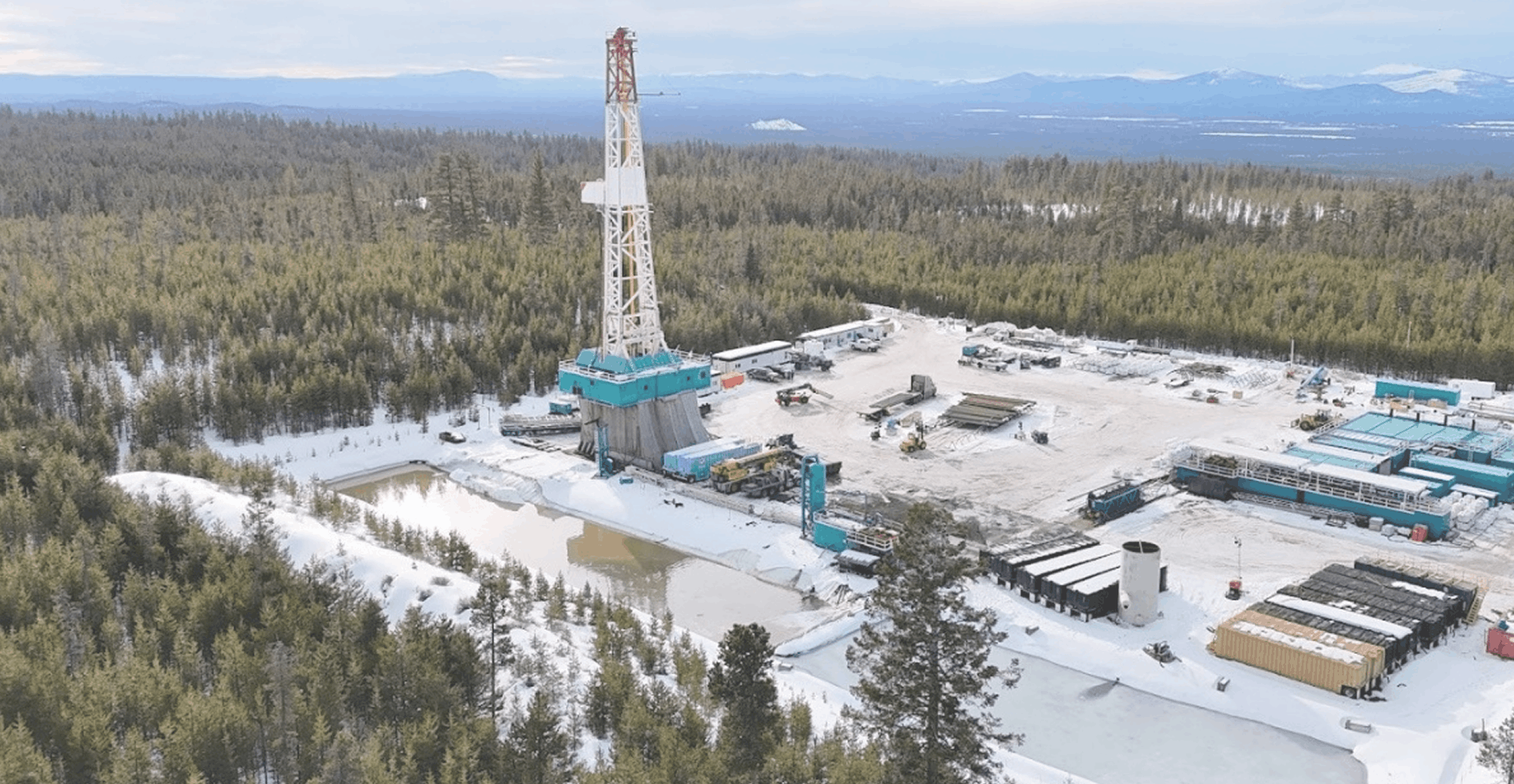 Newberry pilot drilling rig in a forested landscape