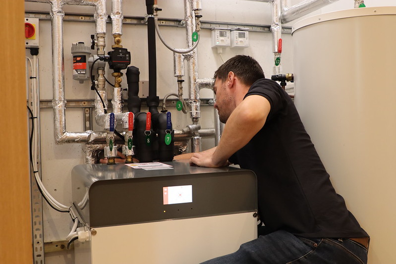 Gareth Berry discussing ground source heat pumps with partner Kensa.