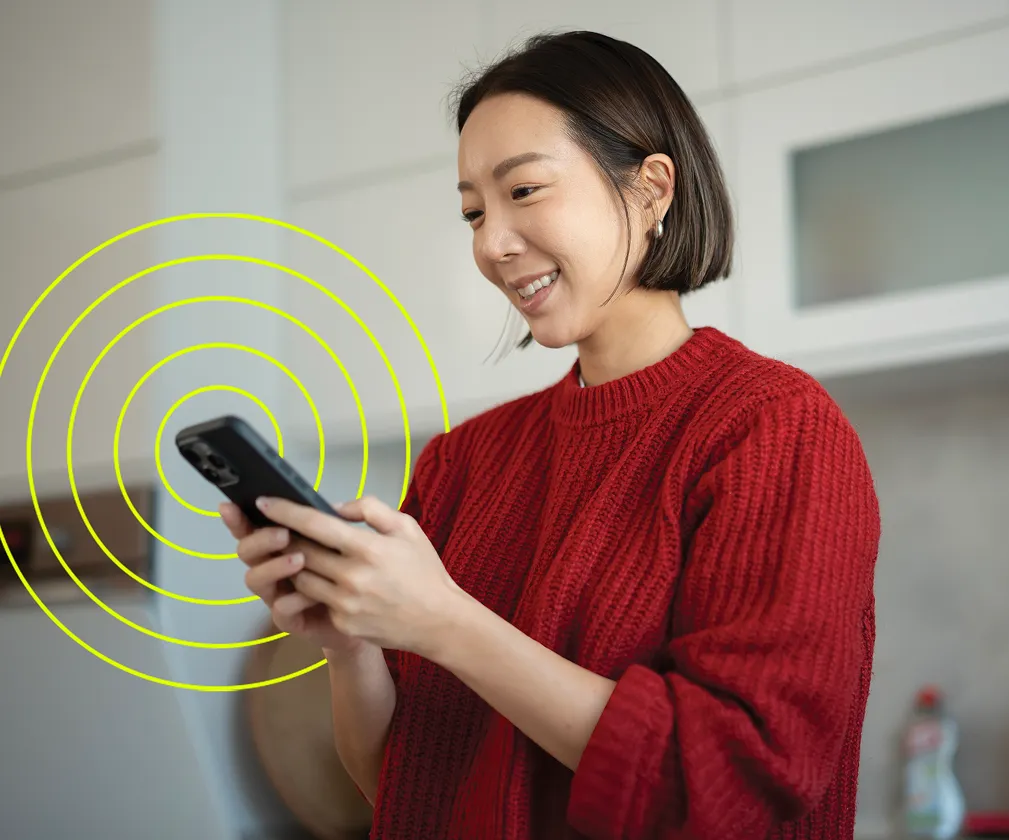Clinician smiling while using her phone