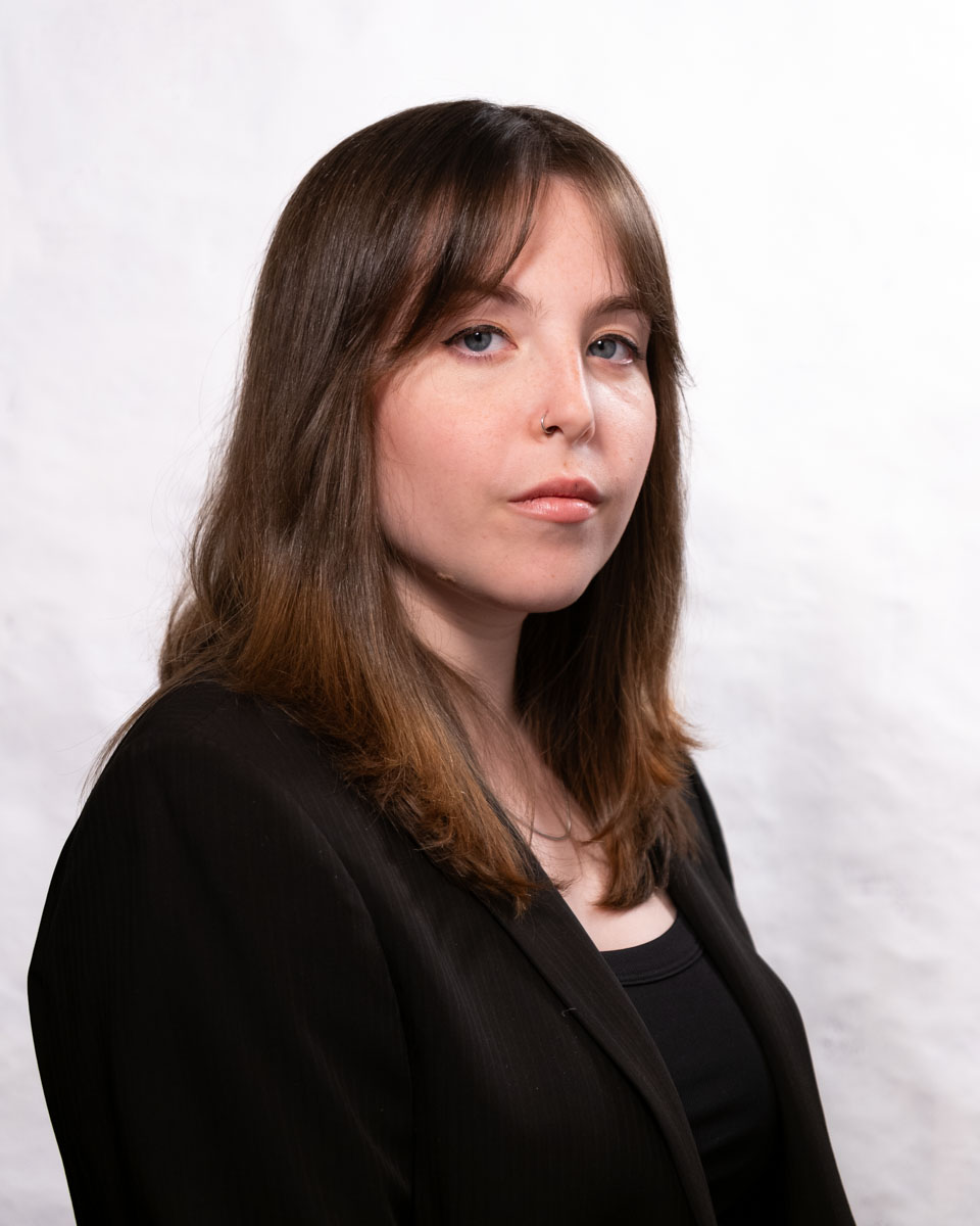 A portrait of a woman against a white background.