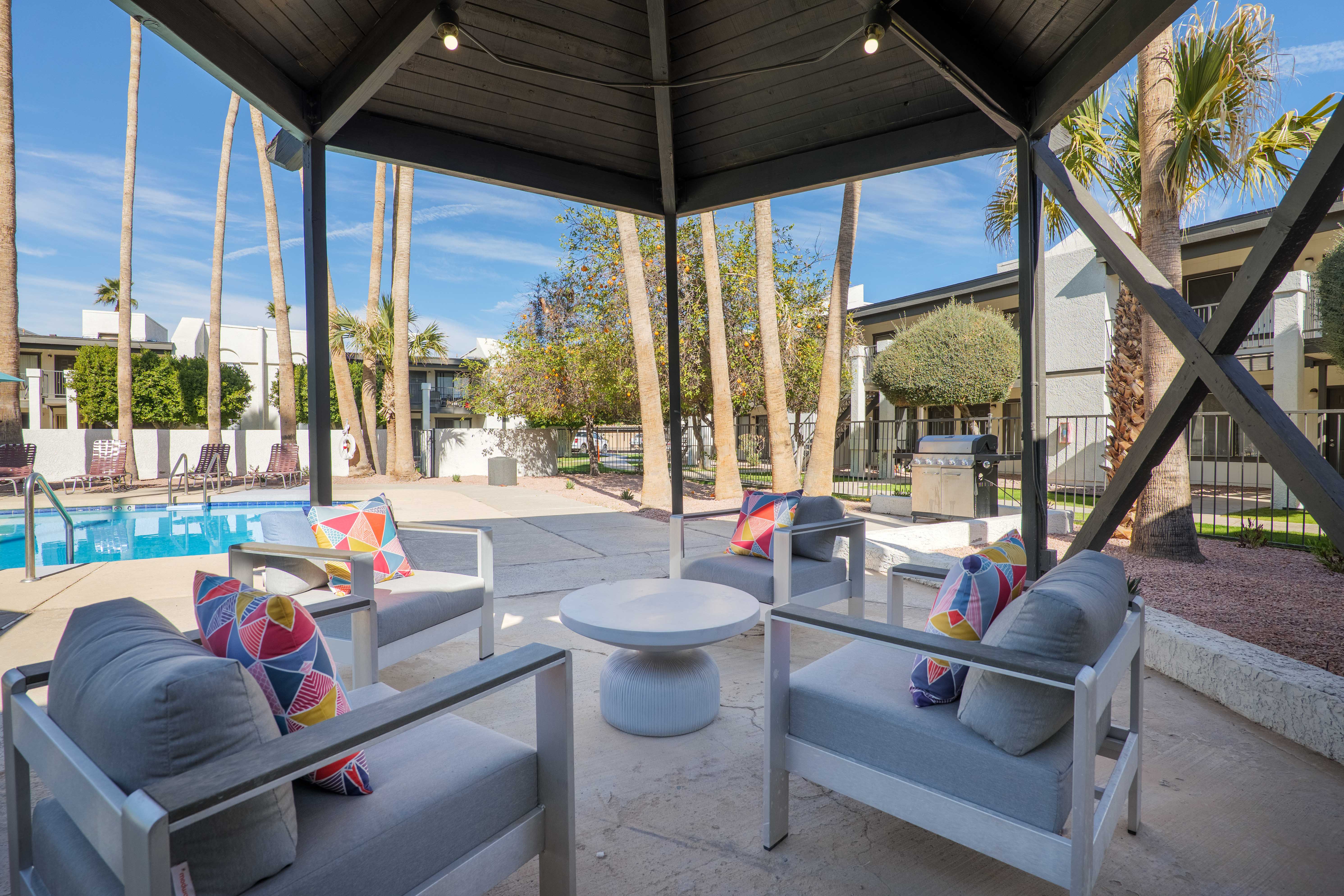 Poolside pavilion with lounge seating and grilling station