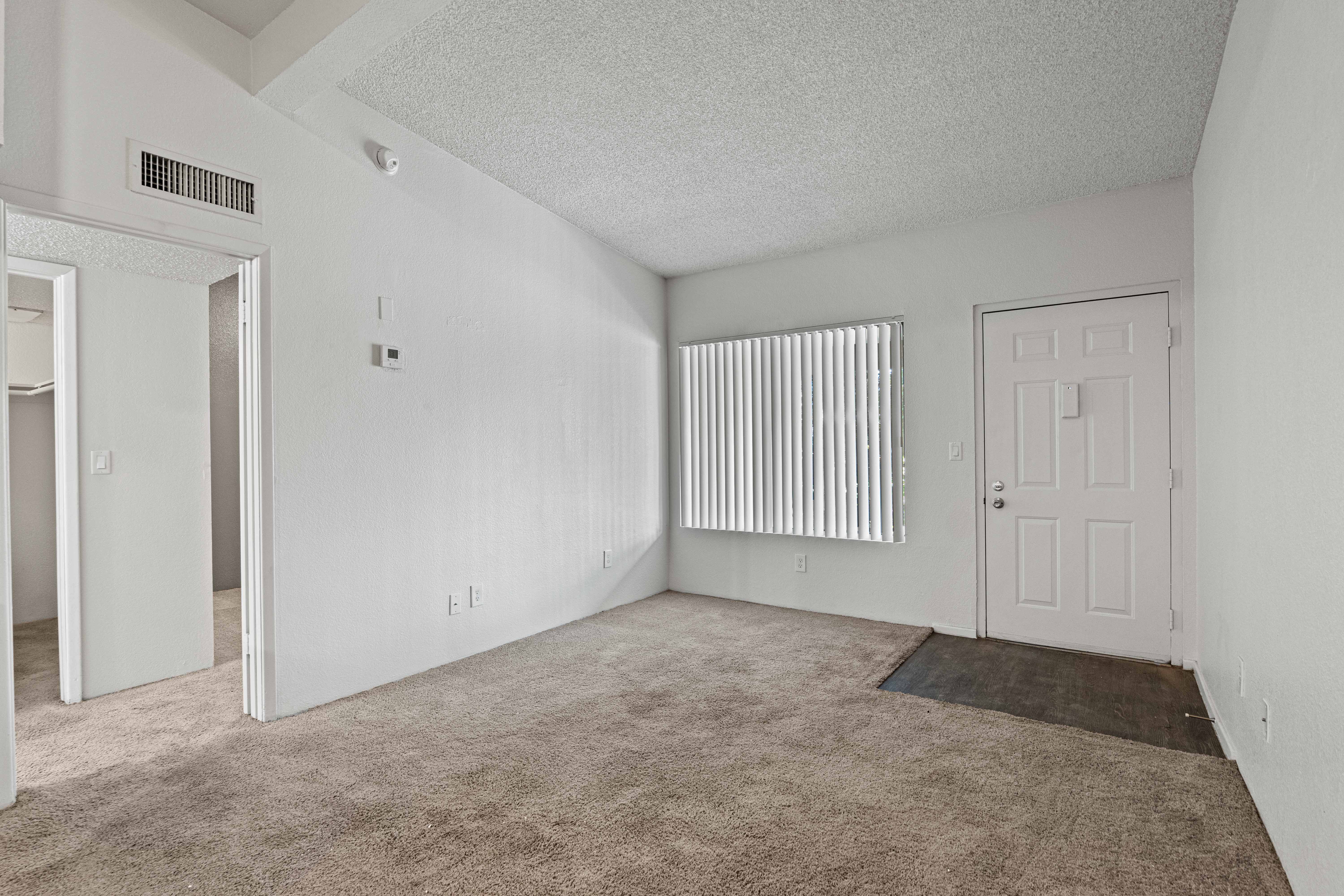 Living room with large window and front entry