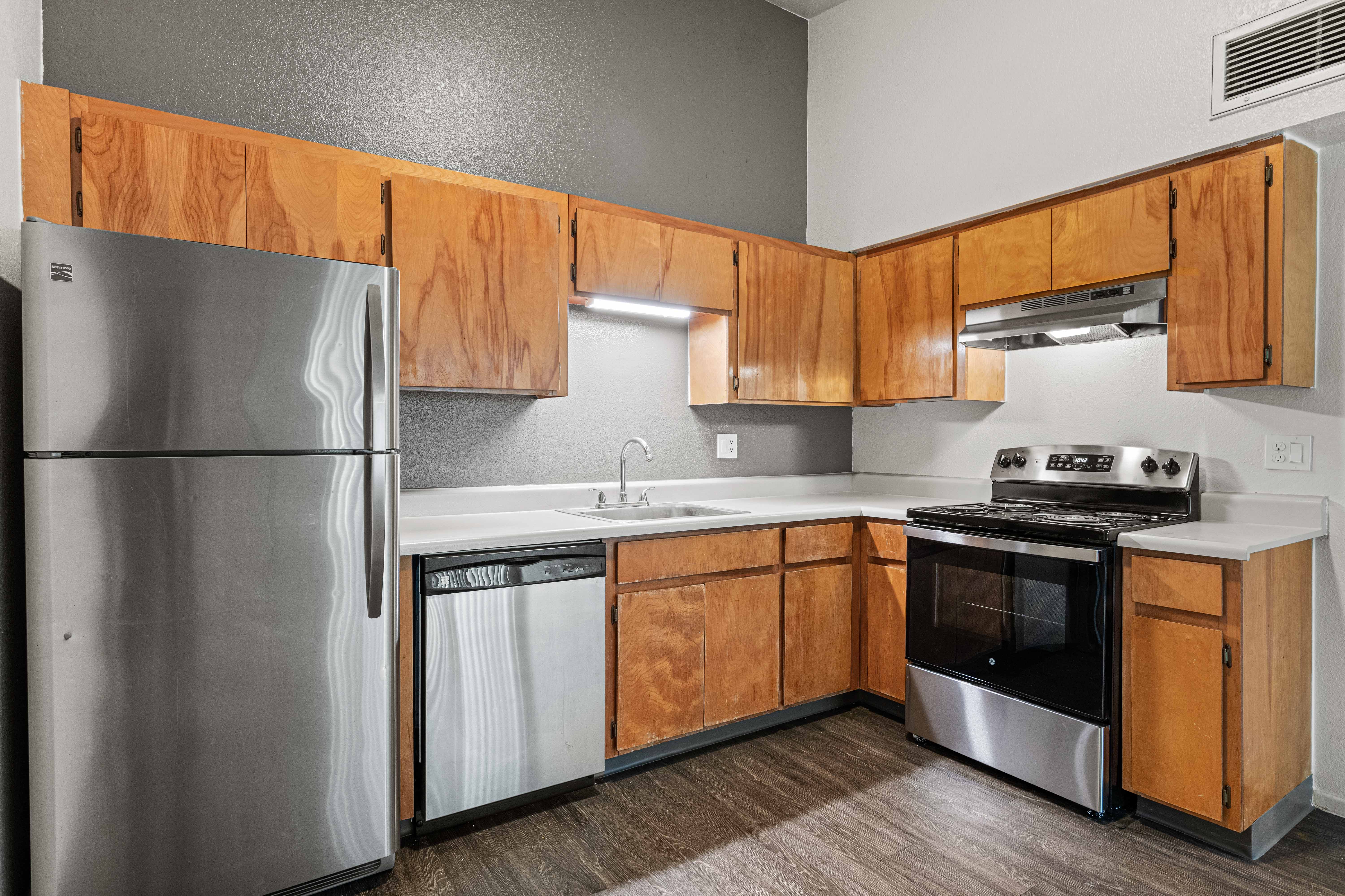 Kitchen with brown cabinets and stainless steel appliances