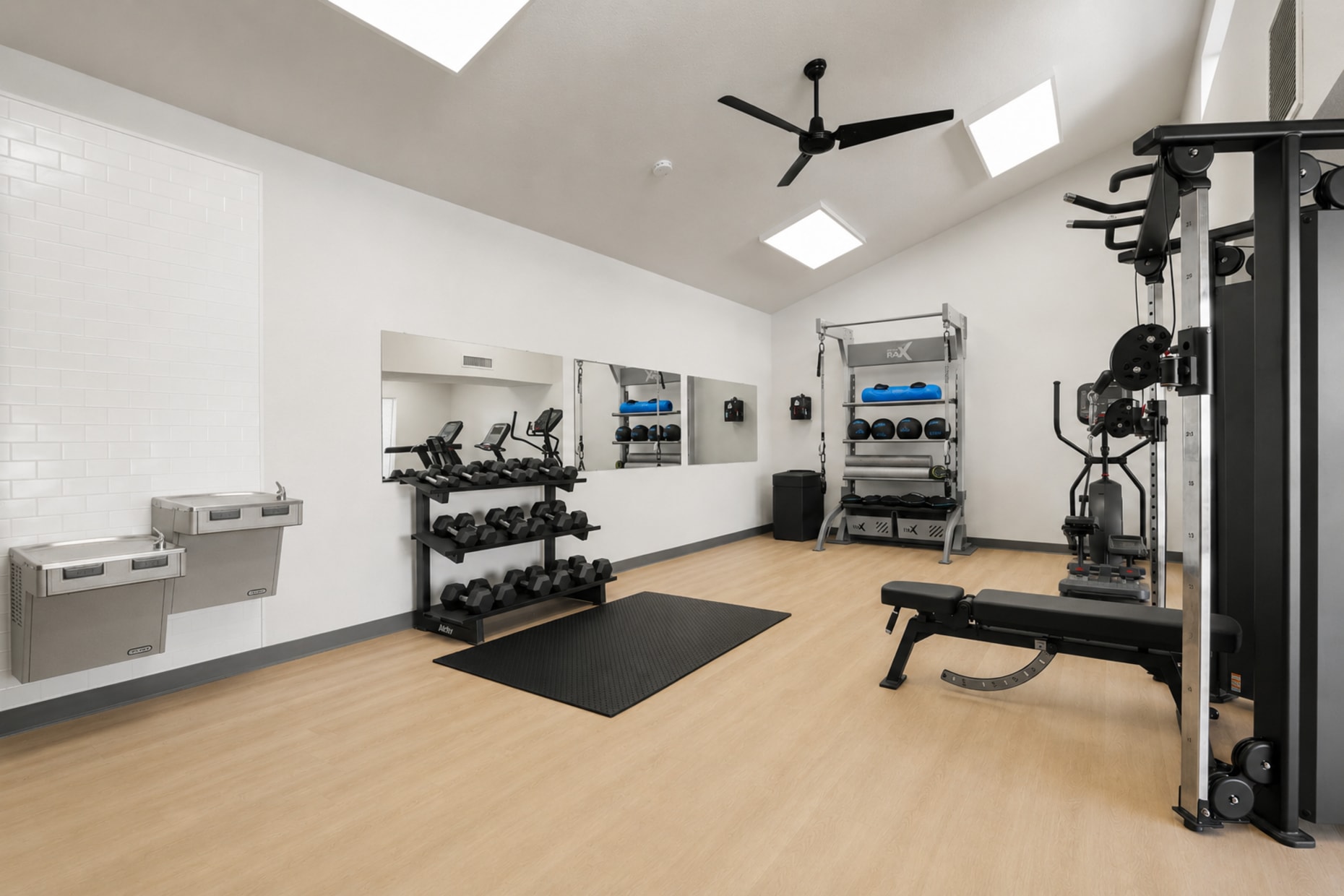 Fitness center with strength training and cardio equipment, corner view